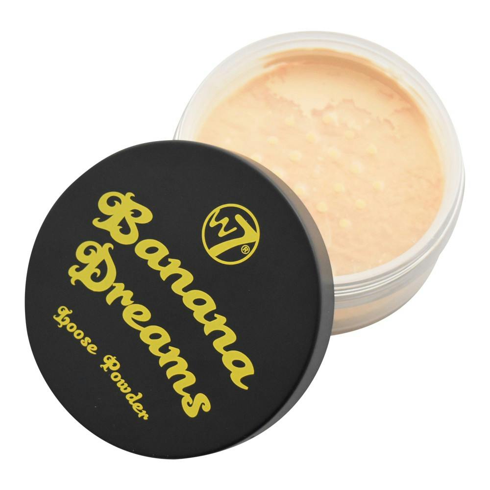 W7 Banana Dreams Loose Powder in a round transparent jar with yellow powder visible through the lid