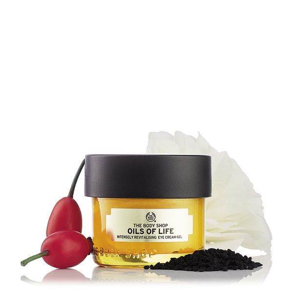 The Body Shop Oils Of Life Intensely Revitalising Eye Cream Gel in a white jar with gold accents, 20ml size